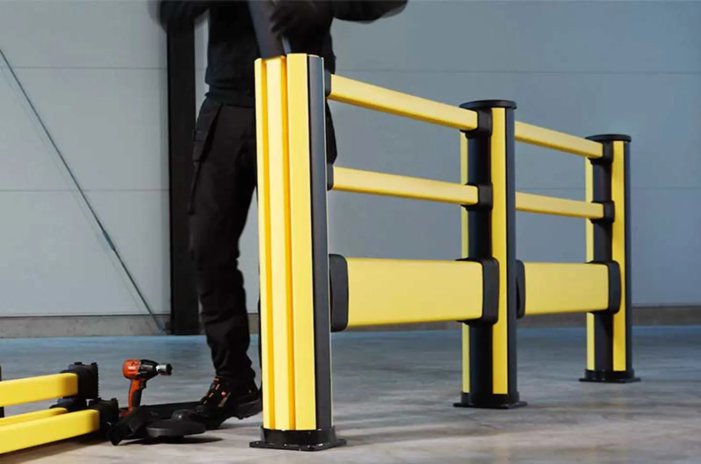 yellow and black pedestrian impact barrier assembly